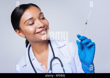 Cheerful female doctor posing with syringe Stock Photo