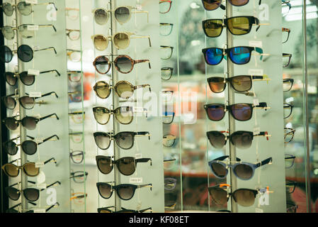 sunglasses sun fashion glasses stacked row in shop display Stock Photo