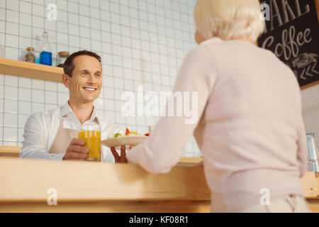 Happy friendly man giving the order Stock Photo