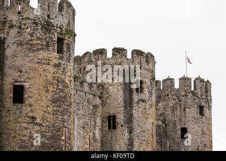 Conwy castle turrets Welsh flag flying in breeze Stock Photo