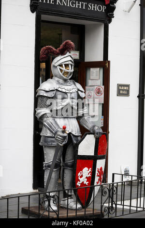 replica of medieval knight in armour with sword and shield
