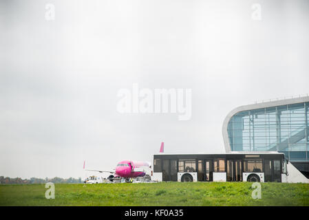 airport view bus with plain near terminal in cloudy day Stock Photo
