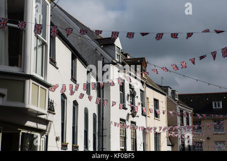 Union Jack bunting hanging and fluttering in the wind above the old high street in Ilfracombe on the North devon coast, UK. Stock Photo