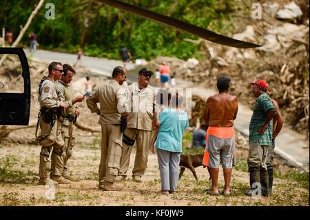 U.S. Customs and Border Protection officers deliver water and emergency supplies to Puerto Rican residents during relief efforts in the aftermath of Hurricane Maria October 11, 2017 near Orovis, Puerto Rico. Stock Photo