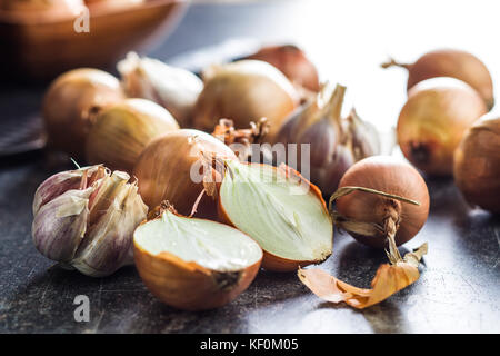 Halved onion bulbs on old kitchen table. Stock Photo