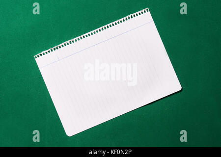 Notebook sheet on green background Stock Photo