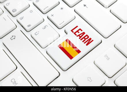 Learn Spanish language education web concept. Spain flag enter button or key on white keyboard Stock Photo