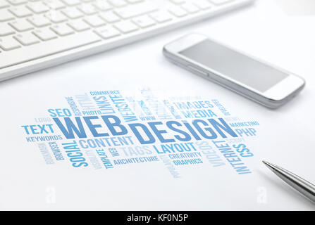 Web Design business concept word cloud print document, keyboard, pen and smartphone, keyboard, pen and smartphone. Blue toned. Stock Photo