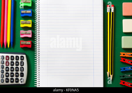 School supplies on green background. Back to school concept. Stock Photo