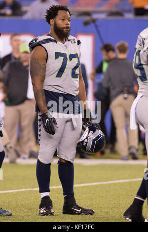 Michael Bennett (72) of the Seattle Seahawks loses his helmet as he tackles  Eddie Lacy (27) of the Green Bay Packers in the NFC Championship game at  CenturyLink Field in Seattle, Washington