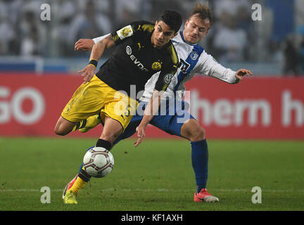 Magdeburg, Germany. 24th Oct, 2017. Dortmund's Marc Bartra (L) and Magdeburg's Felix Lohkemper vie for the ball during the DFB Cup soccer match between 1. FC Magdeburg and Borussia Dortmund in the MDCC Arena in Magdeburg, Germany, 24 October 2017. Credit: Hendrik Schmidt/dpa-Zentralbild/dpa/Alamy Live News Stock Photo