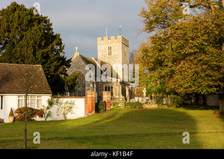 Wickhambreaux, Kent, October 25th 2017. UK Weather. The early morning sunrise lights up the buildings in the pretty village of Wickhambreaus near Canterbury, promising a warmer than usual day for the time of year. However, dark clouds over the fresh crops in the nearby fields suggest that this might not continue for the whole day. 14 degrees Centigrade maximum of 17 C Promised with no rain. Credit: Richard Donovan/ Alamy Live News Stock Photo