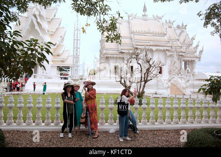 Chiang Rai, Thaliand. 25th Oct, 2017. Preparations are under way to celebrate the royal cremation ceremony of His Majesty the King Bhumibol Adulyadej. Wat Rong Khunor better known as the White Temple uses pieces of glass in the plaster, sparkling in the sun. The white color signifies the purity of the Buddha, while the glass symbolises the Buddha’s wisdom and the Dhamma, the Buddhist teachings. Credit: Paul Quezada-Neiman/Alamy Live News Stock Photo