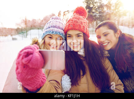 happy teenage girls taking selfie with smartphone Stock Photo