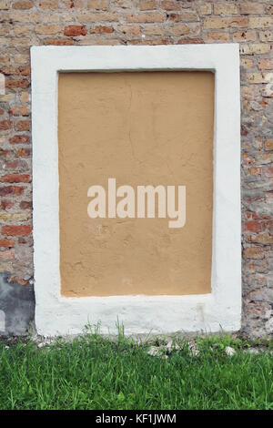 Blind curved basement window in the old red bricks house Stock Photo