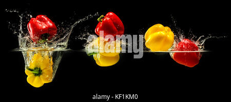 Group of bell pepper falling in water Stock Photo