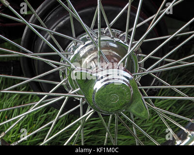 detail of classic car showing chrome hub and spokes of wire wheel of MG roadster sports car Stock Photo