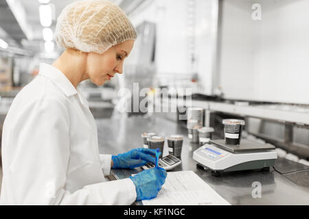 woman working at ice cream factory Stock Photo