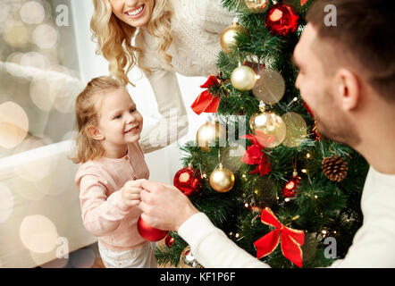happy family decorating christmas tree Stock Photo