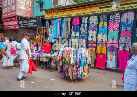 DELHI, INDIA - SEPTEMBER 25 2017: Unidentified people walking at outdoors next to a stores in a dirty streets in Paharganj, Delhi. Delhi is the 2nd most populous city in India after Mumbai Stock Photo