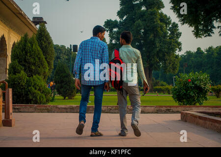 DELHI, INDIA - SEPTEMBER 25 2017: Unidentified gay couple holding their hands and walking around Inlaid marble, columns and arches, Hall of Private Audience or Diwan I Khas at the Lal Qila or Red Fort in Delhi, India, fish eye effect Stock Photo