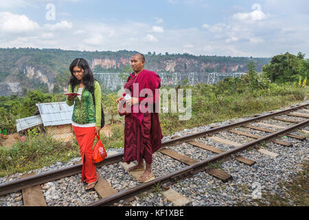 Monk and young woman on the railway line at the Goteik (Goke Hteik) viaduct, a railway trestle in Nawnghkio between Pyin Oo Lwin and Lashio, Myanmar Stock Photo