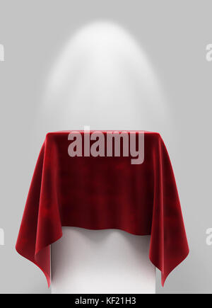 red velor cloth on a square pedestal on a gray background with illumination Stock Photo