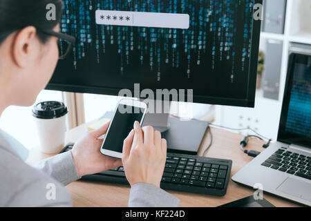 selective focus photo of female office worker touching mobile cell phone screen searching account password safety management service company. Stock Photo