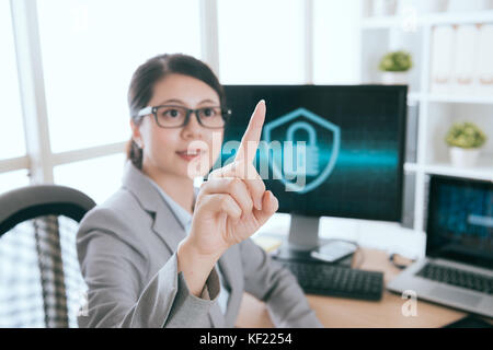 select focus photo. smiling beautiful woman pointing pressing virtual screen interface doing information security working. Stock Photo