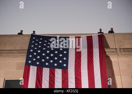A large American flag is unfurled over the west side of the Pentagon at sunrise to mark the 9/11 attacks during the anniversary September 11, 2017 in Washington, D.C. During the attack, 184 people were killed at the Pentagon. Stock Photo