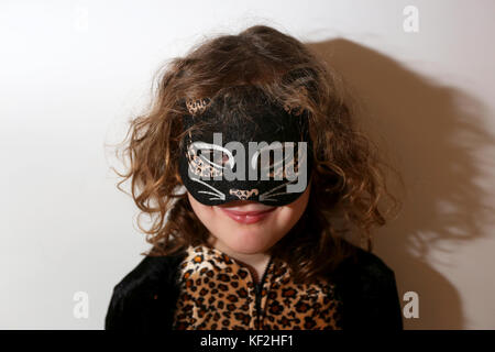 A young 5-year-old girl pictured dressed up as a cat for Halloween fun and celebrations in Chichester, West Sussex, UK. Stock Photo