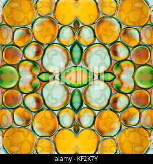 Kaleidoscopic pattern of oil drops on water Stock Photo