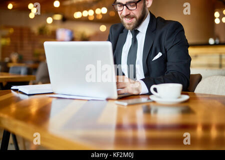 Bearded Manager Using Laptop Stock Photo