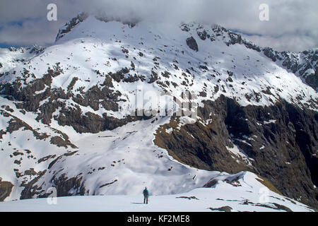 Climber on the slopes of Barrier Knob, above Gertrude Saddle in Fiordland National Park Stock Photo