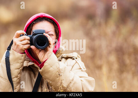 Female looking through the viewfinder Stock Photo