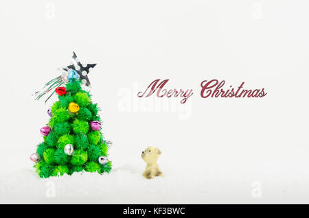 dog looking Christmas tree isolated on white background Stock Photo