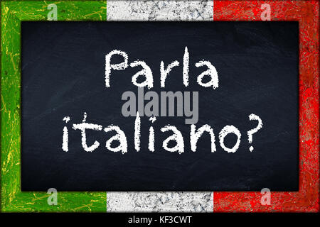 Parla italiano (translation: do you speak italian) language education concept on chalkboard blackboard with wooden italy flag frame Stock Photo