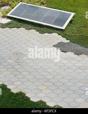 Hexagonal granite tiles on the paths of the public garden. Outdoor top view autumn shot Stock Photo