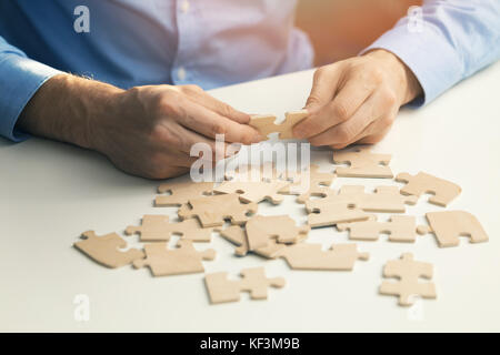 business solutions success and strategy concept. businessman with jigsaw puzzle Stock Photo