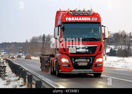 SALO, FINLAND - FEBRUARY 26, 2016: Red MAN tractor unit with a small amount of snow in vehicle grille moves along highway on winter afternoon in South Stock Photo