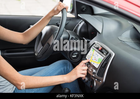 Woman Sitting Inside Car Using GPS Navigation Stock Photo