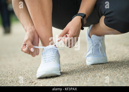 Close-up Of Female Athlete Trying Running Shoes Getting Ready For Jogging Stock Photo