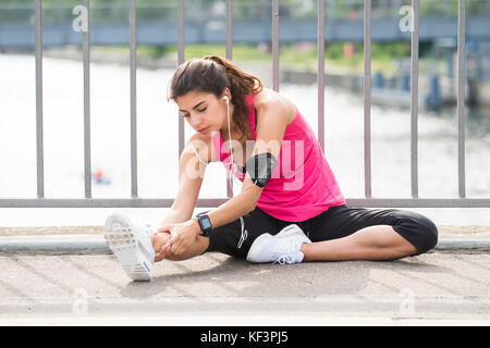 Young Woman Doing Listening To Music While Exercising Stock Photo