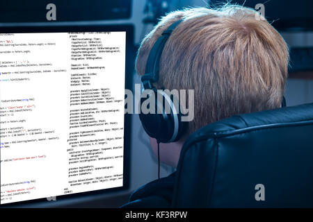 Boy Working On Computer Listening To Music Stock Photo