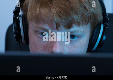Close-up Of A Boy Working On Computer Stock Photo