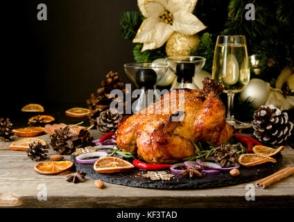 Roast chicken or turkey for Christmas and New Year with mulled wine and Christmas decorations, space for text, selective focus Stock Photo