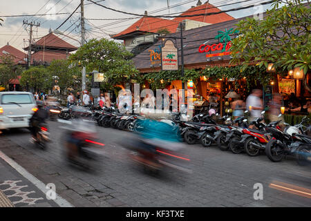 Traffic on Jalan Raya Street at dusk. Ubud town, Bali, Indonesia. Stock Photo
