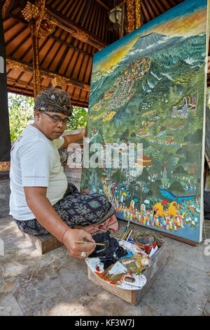 Balinese artist working at the Agung Rai Museum of Art (ARMA). Ubud, Bali, Indonesia. Stock Photo