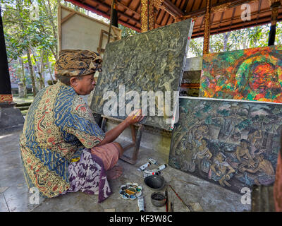 Local artist working at the Agung Rai Museum of Art (ARMA). Ubud, Bali, Indonesia. Stock Photo