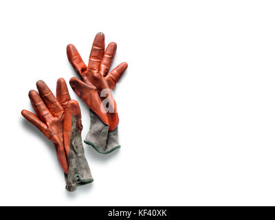 Dirty worn orange rubber coated work gloves on white Stock Photo